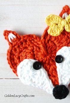 a crocheted fox with a bow on it's head