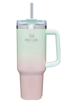 the tumbler cup is pink and green with a straw sticking out of it's side