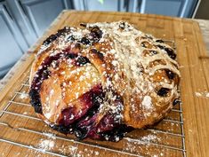 a pastry sitting on top of a wooden cutting board