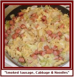 a pan filled with sausage and noodles on top of a stove