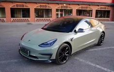 a silver car parked in front of a building