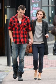 a man and woman walking down the street