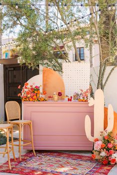 an outdoor bar decorated with flowers and succulents