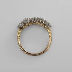 an antique ring with five diamonds