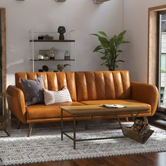 a living room filled with furniture next to a large glass window and wooden flooring