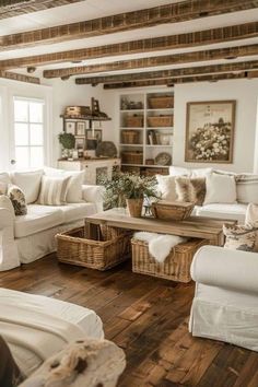 a living room filled with white furniture and lots of pillows on top of it's couches