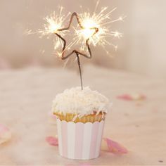 a star shaped sparkler on a white surface