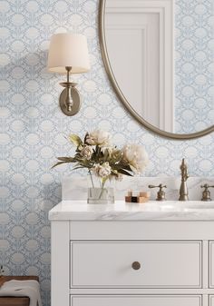 a bathroom vanity with a mirror and flowers on it