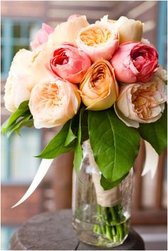 a vase filled with lots of flowers on top of a table