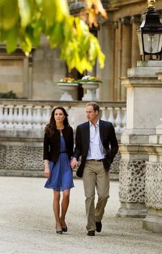 a man and woman are walking down the street