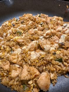 chicken and rice in a skillet being cooked