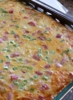 a casserole dish with ham, cheese and green onions