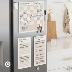 a refrigerator with magnets on it in a kitchen next to a counter and cabinets