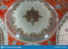 an ornate ceiling in the interior of a building with red and white tiles on it