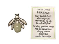 a brooch with a poem written on it next to a card that says lucky little firefly