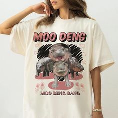 Comfort Color Moo Deng Shirt, Moo Deng Shirt, Cute Baby Hippo Moo Deng Bouncy Pig in Thai Shirt, Hippo Lover Funny Shirt V5 🔥🔥We will provide you two alternatives for Comfort Color: Pepper and Ivory. Gildan's color palette will be used for all other colors🔥🔥 👕Material: Tshirt: 100% cotton. Sweatshirt & Hoodie: 50% cotton and 50% polyester. 📦Shipping: Processing Time 2 - 4 business days Shipping Time 5 - 7 business days 💦Care instructions: Machine wash: warm (max 40C or 105F); Non-chlorine Party Animal Mom Shirt, Comfort Color, Funny Shirt, Sweatshirt Hoodie, Funny Shirts, Color Palette, Care Instructions, Adult Outfits, Tops & Tees