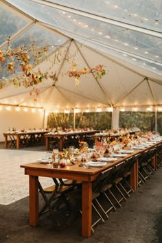 a large tent with tables and chairs set up for an event