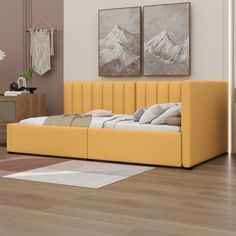 a yellow day bed sitting on top of a hard wood floor