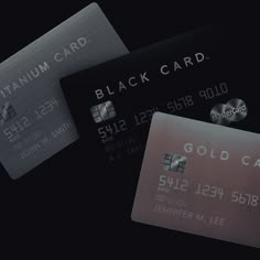 three credit cards are shown in black and silver