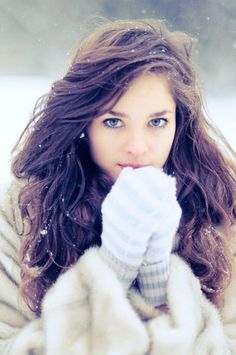 a woman with long hair wearing a fur coat