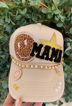 Hat chains are removable with clasps on each end. They can be bought separate or with the hat. Please allow up to 2 weeks for this hat to ship as this is a pre-order item.  $10-$12 chain options do not include hats.  $40-$50 bling hat options do include trucker hat and bling as pictured.  For clarification when purchasing: If you purchase one of the hat chain options, this is individual hat chains and DOES NOT include the trucker hat. If you purchase the bling hat option, this option includes th Customized Trucker Hats, Summer Trucker Hats For Women, Trendy Gold Snapback Hat, Trendy Gold Cap, Mom Trucker Hats, Trendy Adjustable Gold Hats, Adjustable Gold Hats For Gifts, Handmade Gold Hat For Gift, Gold Adjustable Trucker Hat Trendy