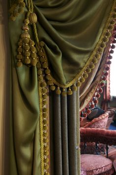 a curtain with tassels hanging from it's sides