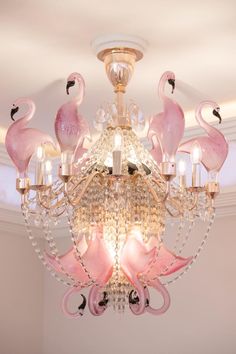 a chandelier that has pink flamingos on it