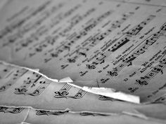 an old sheet of music paper with musical notes on it's edges and torn off