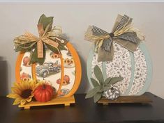 two decorative pumpkins are sitting on a table