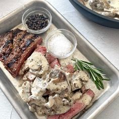 steak, mushrooms, and other food items on a tray