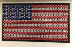 an american flag made out of bottle caps is displayed on the wall in this room