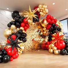 a large balloon arch decorated with black, red and gold balloons