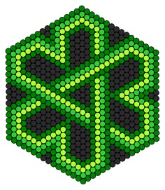 a green and black hexagonal object with dots