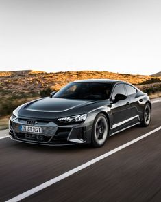 a grey car driving down the road