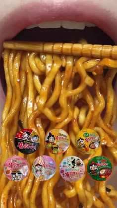 a bunch of food is sticking out of a container with some stickers on it