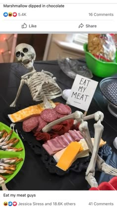 a table topped with lots of food and skeleton figurines on top of it