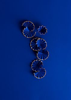 three small blue umbrellas sitting on top of a blue table next to each other