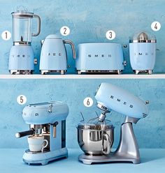 blue kitchen appliances are lined up on the shelf next to each other, including a mixer and blender