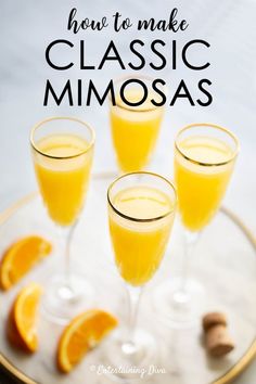 three glasses filled with orange juice and garnished with cinnamon on a white plate