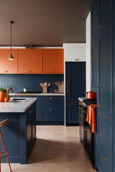 a kitchen with blue cabinets and orange accents