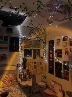 a dorm room with lights strung from the ceiling and pictures on the wall above it