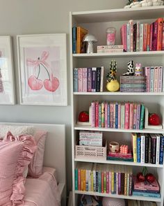 a book shelf filled with books next to a bed