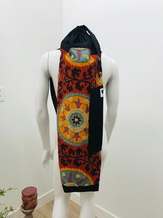 a mannequin wearing a colorful dress with an unusual design on it's back