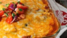 a casserole dish with tomatoes, onions and green peppers on top is ready to be eaten