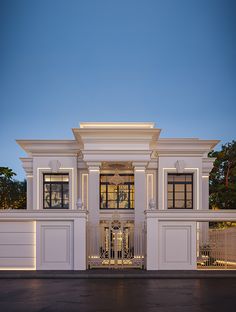 a large white building with columns on the front and side walls, lit up at night