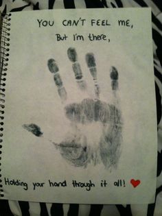 a handprint on a spiral notebook that says, you can't feel me, but i'm there, holding your hand through it all