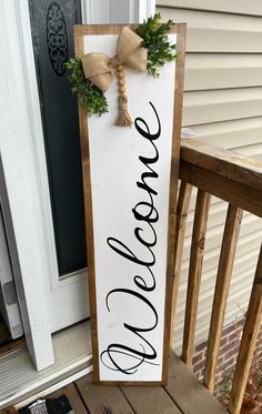 Welcome! :) This listing is for my handmade Front Porch Leaner that reads, "Welcome" The porch sign is fully stained in front & back, painted, sealed & then topped with an adorable bow & greenery! This porch leaner is great for a year-round modern farmhouse vibe! It also would make a fun & easy gift for family and friends! - This sign is about 4ft tall and 11.75 inches wide. - Stained in Aged Wood OR light brown Early American. (not pictured) but is a light brown. - Painted in Acrylic black - Ri House Number Signs Front Porches, Diy Welcome Sign Wood Front Porches, Door Leaner Signs, Front Porch Signs Wooden Diy, Diy Welcome Sign Wood, Small Front Porch Ideas Entrance, Welcome Signs For Front Door, Welcome Porch Leaner, The Porch Sign