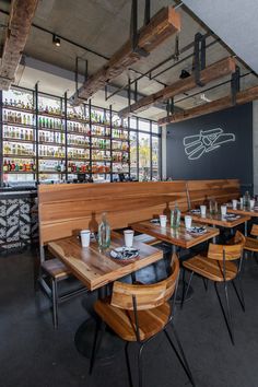 an empty restaurant with wooden tables and chairs