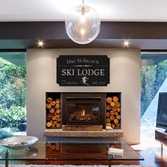 a living room with a glass table and fireplace