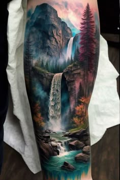 a man's arm with a waterfall and trees on it